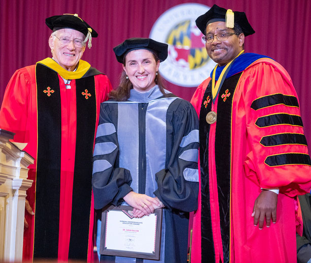 Sarah Balcom stands with UMD President Darryll J. Pines and Chancellor Emeritus William E. Kirwan