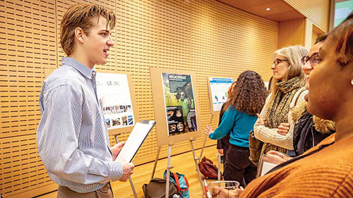 Student Brian Spinner talking with some event attendees