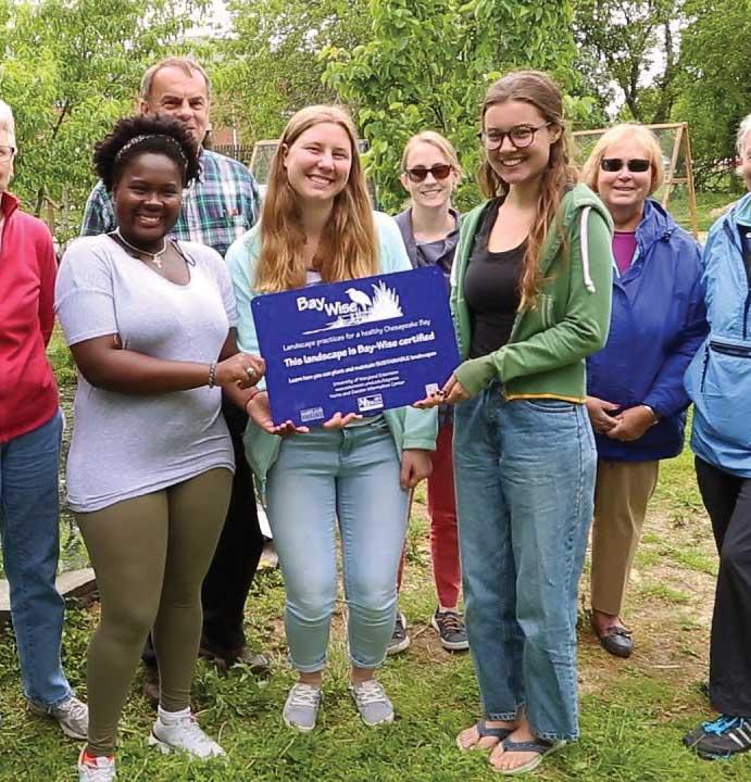 A group of Marylanders smiling in a group after their garden was certified as a Bay Community Garden.