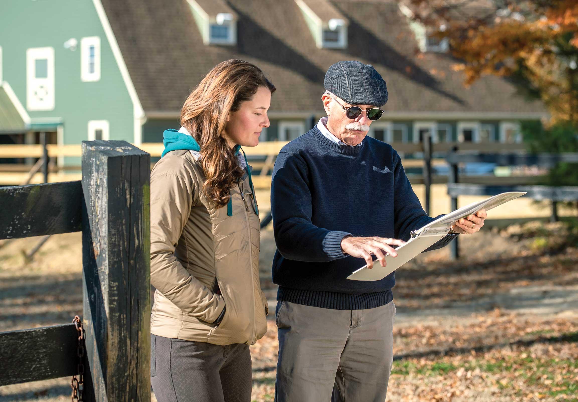 Craig Yohn studying a nutrient input plan outside with a client. 