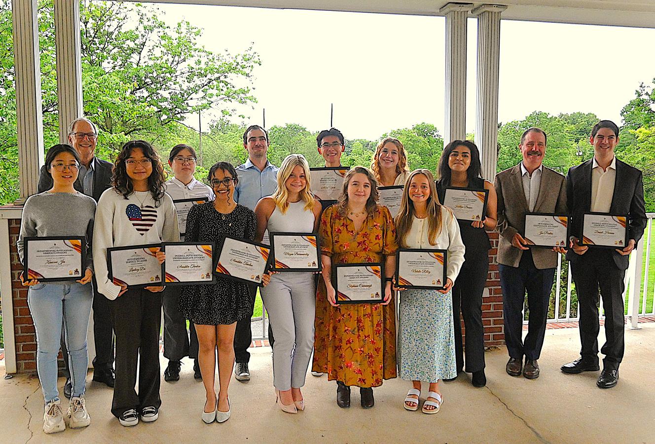 Award winners holding their certificates together with Dean Beyrouty